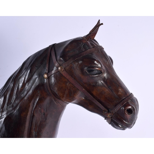 304 - A LARGE EARLY 20TH CENTURY COUNTRY HOUSE LEATHER FIGURE OF A STANDING HORSE. 46 cm x 44 m.