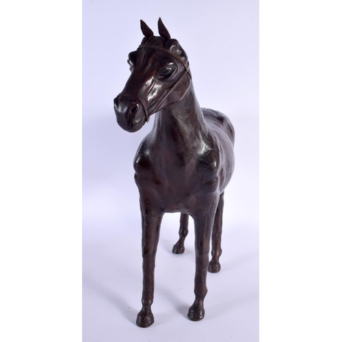 304 - A LARGE EARLY 20TH CENTURY COUNTRY HOUSE LEATHER FIGURE OF A STANDING HORSE. 46 cm x 44 m.