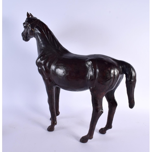 304 - A LARGE EARLY 20TH CENTURY COUNTRY HOUSE LEATHER FIGURE OF A STANDING HORSE. 46 cm x 44 m.