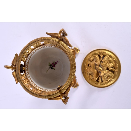 31 - A 19TH CENTURY FRENCH ORMOLU AND PORCELAIN INKWELL painted with flowers. 15 cm x 7 cm.