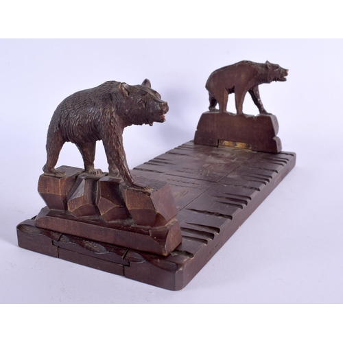 336 - A LATE 19TH CENTURY BAVARIAN BLACK FOREST SLIDING WOOD BOOK RACK formed as standing bears. 44 cm lon... 