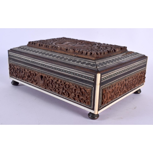 345 - A 19TH CENTURY ANGLO INDIAN CARVED SANDALWOOD CASKET decorated with figures. 21 cm x 14 cm.