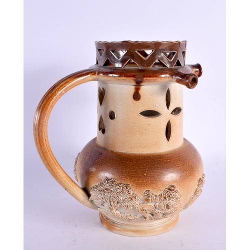 352 - AN UNUSUAL 19TH CENTURY ENGLISH STONEWARE PUZZLE JUG decorated with hunting scenes. 20 cm high.