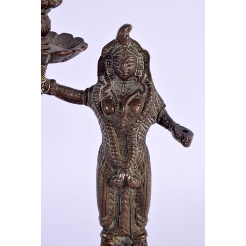 355 - A PAIR OF 19TH CENTURY MIDDLE EASTERN INDIAN BRONZE CANDLESTICKS formed as deities holding aloft sco... 