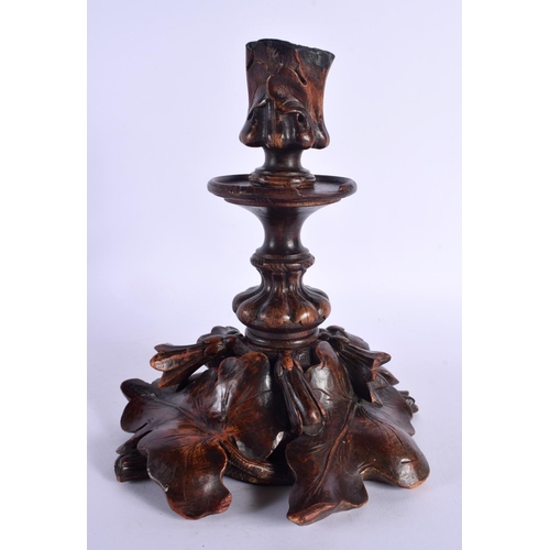 357 - A LARGE 19TH CENTURY BAVARIAN BLACK FOREST CARVED WOOD CANDLESTICKS overlaid with leaves. 26 cm x 12... 