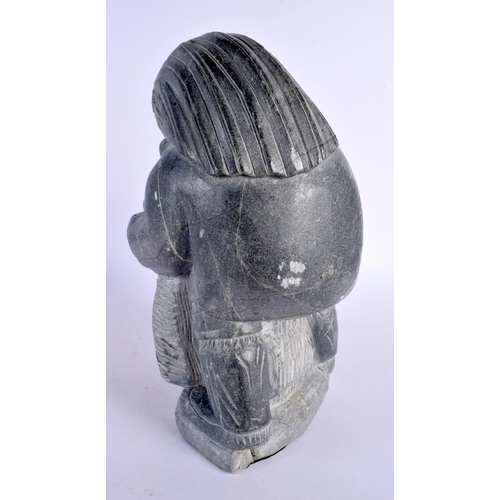 358 - AN UNUSUAL LARGE NORTH AMERICAN INUIT CARVED STONE FIGURE modelled as an hunter. 30 cm x 13 cm.