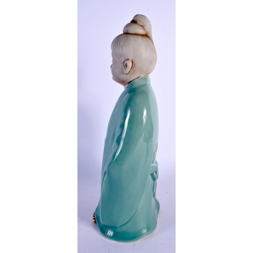 366 - AN UNUSUAL EARLY 20TH CENTURY JAPANESE TAISHO PERIOD CELADON PORCELAIN FIGURE modelled as a young bo... 