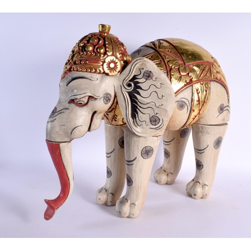 383 - A LARGE INDIAN FOLK ART CARVED AND PAINTED WOOD CIRCUS ELEPHANT modelled with gilt embellished highl... 