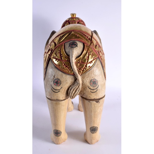 383 - A LARGE INDIAN FOLK ART CARVED AND PAINTED WOOD CIRCUS ELEPHANT modelled with gilt embellished highl... 