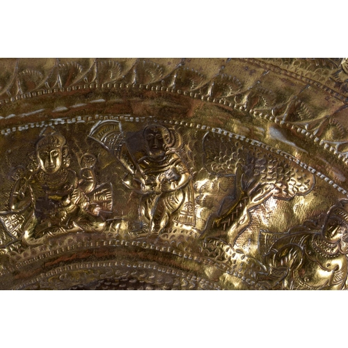 384 - A LARGE 19TH CENTURY MIDDLE EASTERN INDIAN EMBOSSED CHARGER decorated with figures in various pursui... 