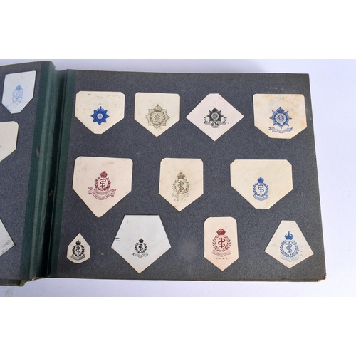 386 - A COLLECTION OF WWI MILITARY REGIMENTAL CUT OUTS together with photographs and a watercolour of Ypre... 