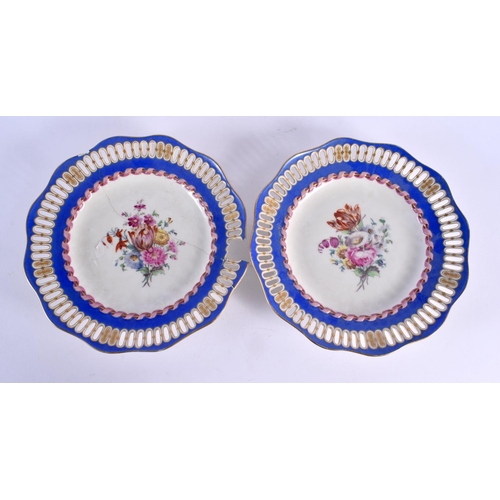 39 - A PAIR OF 19TH CENTURY BERLIN RETICULATED PORCELAIN PLATES painted with flowers. 24 cm wide.