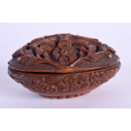 397 - A LATE 18TH CENTURY CONTINENTAL CARVED COQUILLA NUT SNUFF BOX depicting arms. 6.75 cm x 4 cm.