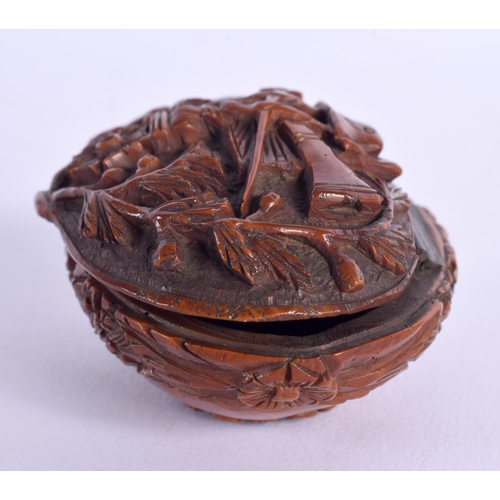 397 - A LATE 18TH CENTURY CONTINENTAL CARVED COQUILLA NUT SNUFF BOX depicting arms. 6.75 cm x 4 cm.