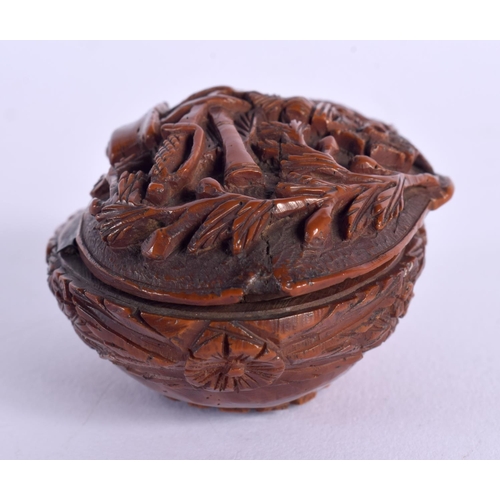 397 - A LATE 18TH CENTURY CONTINENTAL CARVED COQUILLA NUT SNUFF BOX depicting arms. 6.75 cm x 4 cm.