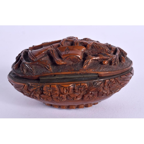 397 - A LATE 18TH CENTURY CONTINENTAL CARVED COQUILLA NUT SNUFF BOX depicting arms. 6.75 cm x 4 cm.