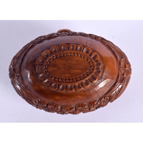 397 - A LATE 18TH CENTURY CONTINENTAL CARVED COQUILLA NUT SNUFF BOX depicting arms. 6.75 cm x 4 cm.