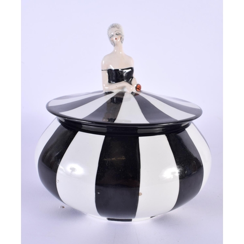 4 - A RARE ART DECO CARLTONWARE POWDER BOX AND COVER formed as a female wearing a black and white dress.... 