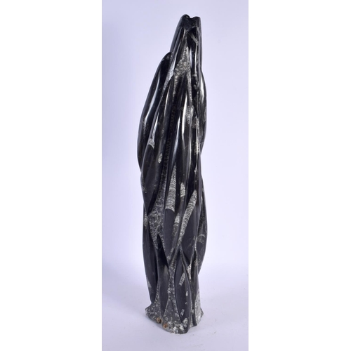 402 - A LARGE STYLISH FOSSILISED STONE SCULPTURE. 54 cm high.