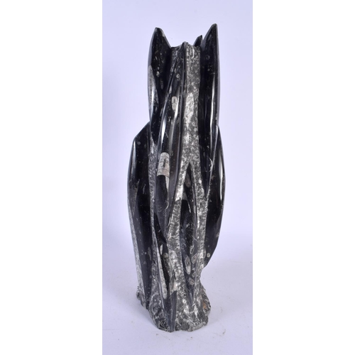 403 - A SMALLER STYLISH FOSSILISED STONE SCULPTURE. 34 cm high.