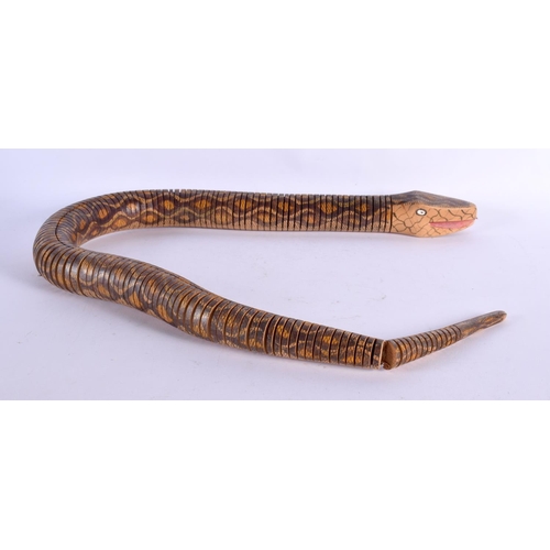 422 - A CHARMING VINTAGE FOLK ART RETICULATED WOODEN SNAKE. 90 cm long.