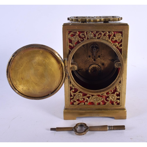 437 - AN ANTIQUE BRASS OPENWORK CARRIAGE CLOCK with circular enamel dial. 16 cm high inc handle.