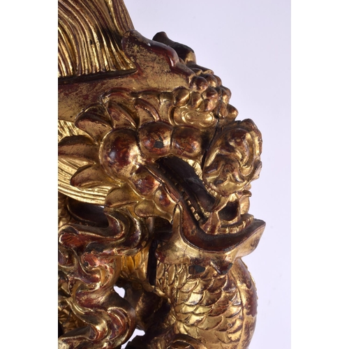 444 - A LARGE PAIR OF 19TH CENTURY SOUTH EAST ASIAN CHINESE PAINTED WOOD DRAGONS modelled upon rectangular... 