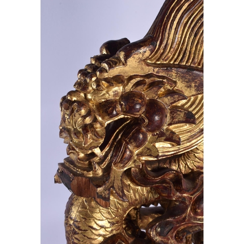 444 - A LARGE PAIR OF 19TH CENTURY SOUTH EAST ASIAN CHINESE PAINTED WOOD DRAGONS modelled upon rectangular... 