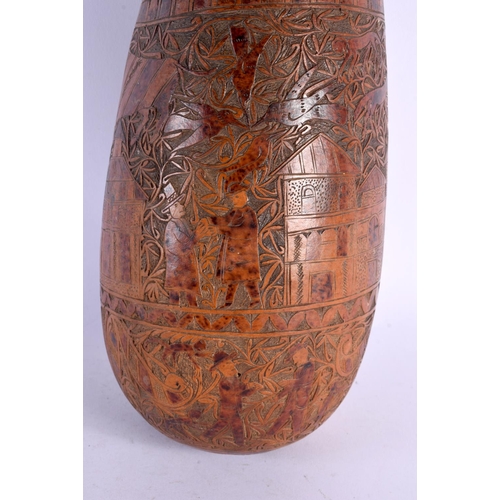 454 - AN UNUSUAL LARGE 19TH CENTURY CONTINENTAL ENGRAVED GOURD NUT decorated with figures in landscapes. 4... 