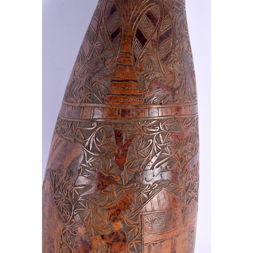 454 - AN UNUSUAL LARGE 19TH CENTURY CONTINENTAL ENGRAVED GOURD NUT decorated with figures in landscapes. 4... 