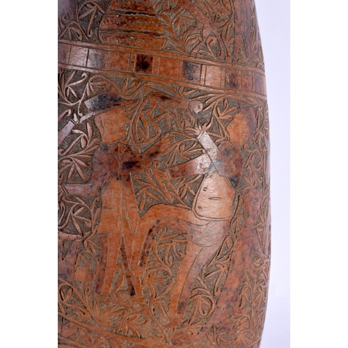 454 - AN UNUSUAL LARGE 19TH CENTURY CONTINENTAL ENGRAVED GOURD NUT decorated with figures in landscapes. 4... 