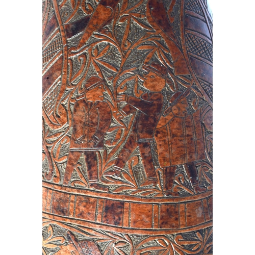 454 - AN UNUSUAL LARGE 19TH CENTURY CONTINENTAL ENGRAVED GOURD NUT decorated with figures in landscapes. 4... 