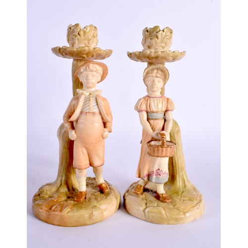 46 - A PAIR OF ROYAL WORCESTER FIGURAL CANDLESTICKS. 19 cm high.