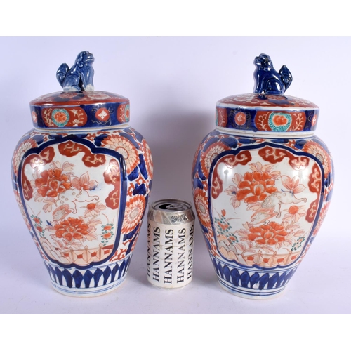 481 - A PAIR OF 19TH CENTURY JAPANESE MEIJI PERIOD IMARI JARS AND COVERS painted with flowers. 32 cm x 12 ... 