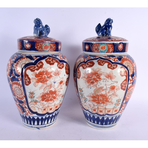 481 - A PAIR OF 19TH CENTURY JAPANESE MEIJI PERIOD IMARI JARS AND COVERS painted with flowers. 32 cm x 12 ... 