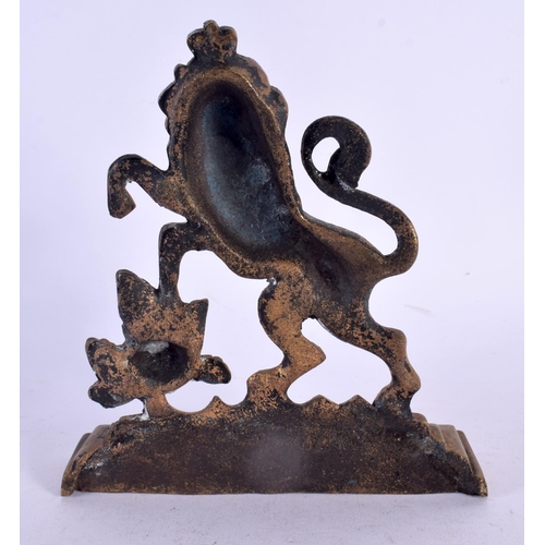 491 - AN ANTIQUE BRONZE LION DOOR STOP. 15 cm x 12 cm.