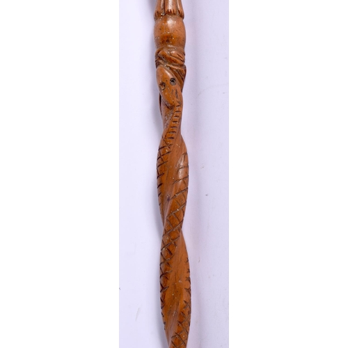 496 - AN ANTIQUE CONTINENTAL FOLK ART CARVED WOOD TRIBAL WALKING STAFF decorated with snakes and females. ... 