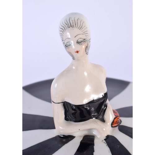 4 - A RARE ART DECO CARLTONWARE POWDER BOX AND COVER formed as a female wearing a black and white dress.... 