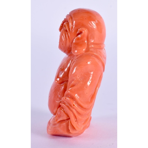 555 - A SMALL 19TH CENTURY CHINESE CARVED RED CORAL FIGURE OF A BUDDHA Qing. 42 grams. 5 cm x 3.5 cm.