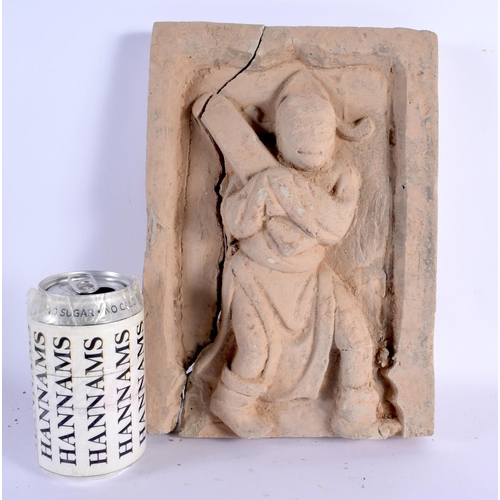 558 - A CHINESE SUNG DYNASTY POTTERY BRICK TILE modelled with a roaming figure of a scribe. 27 cm x 19 cm.