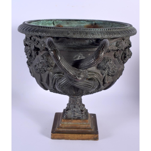 562 - A LARGE 19TH CENTURY BRONZE WARWICK VASE with entwined handles, decorated with classical mask heads.... 