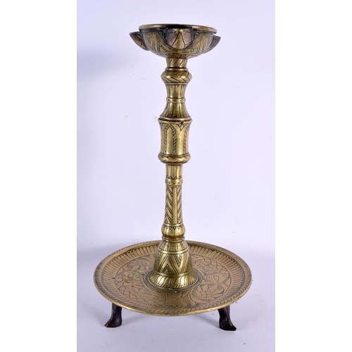 577 - AN 18TH/19TH CENTURY MIDDLE EASTERN INDIAN BRONZE CANDLESTICK. 32 cm x 12 cm.