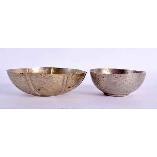 634 - TWO VINTAGE CONTINENTAL WHITE METAL BOWLS together with an Islamic dish. Largest 18 cm wide. (3)