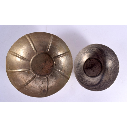 634 - TWO VINTAGE CONTINENTAL WHITE METAL BOWLS together with an Islamic dish. Largest 18 cm wide. (3)