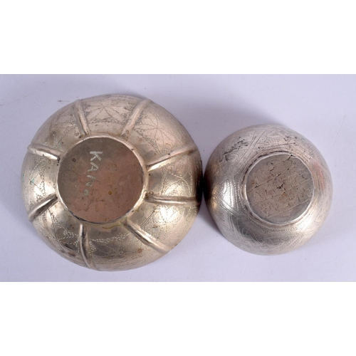 634 - TWO VINTAGE CONTINENTAL WHITE METAL BOWLS together with an Islamic dish. Largest 18 cm wide. (3)