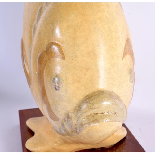 640 - A LARGE CONTINENTAL PORCELAIN FIGURE OF A FISH upon a wooden base. 34 cm x 30 cm.