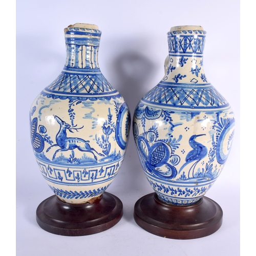 660 - A LARGE PAIR OF 18TH/19TH CENTURY SPANISH TIN GLAZED JUGS painted with deer within landscapes. 44 cm... 