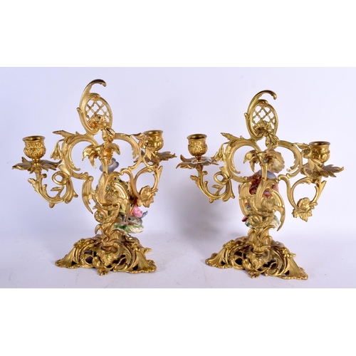 694 - A PAIR OF 19TH CENTURY FRENCH GILT BRONZE AND PORCELAIN COUNTRY HOUSE CANDLESTICKS formed with figur... 