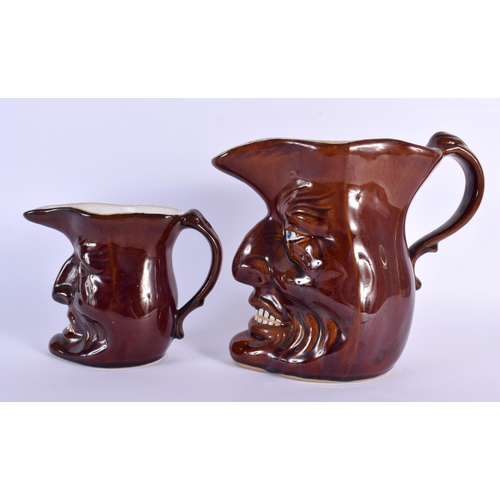 699 - TWO UNUSUAL EARLY 20TH CENTURY CONTINENTAL POTTERY JUGS modelled as grotesque males. Largest 24 cm x... 