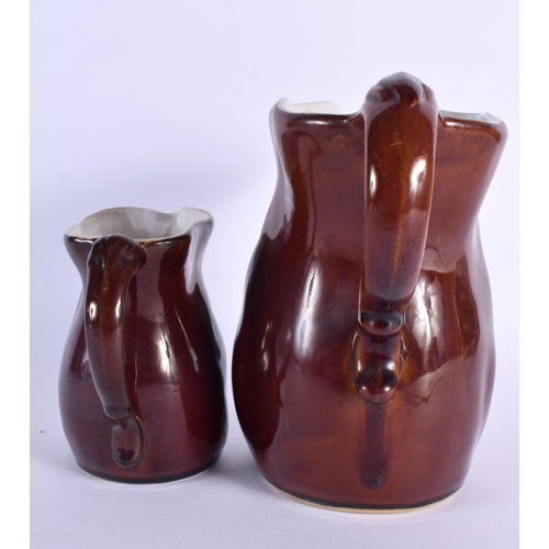 699 - TWO UNUSUAL EARLY 20TH CENTURY CONTINENTAL POTTERY JUGS modelled as grotesque males. Largest 24 cm x... 